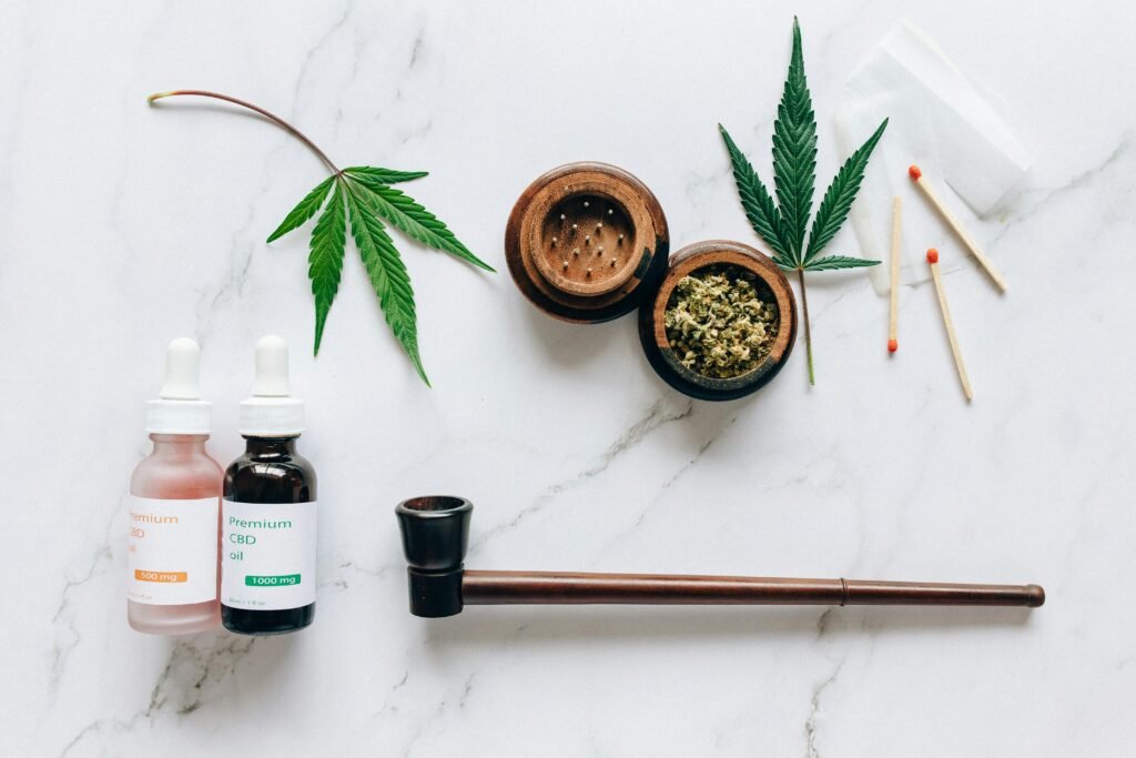 medical cannabis with a pipe and grander on table with matches