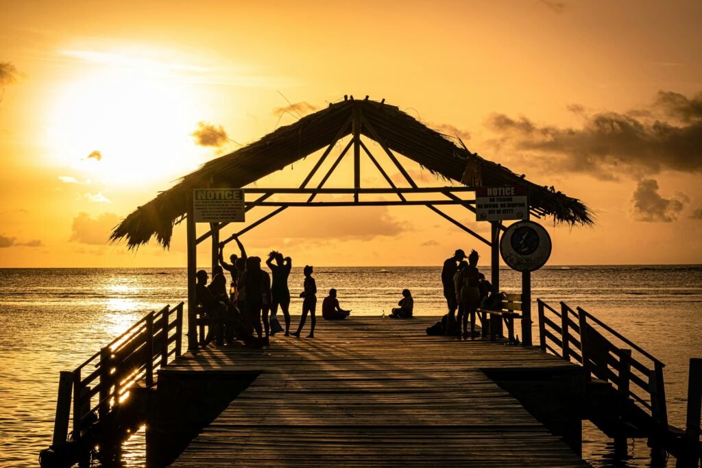 Long jetty at sunset in Tobago. With people enjoying the view and the lifestyle.